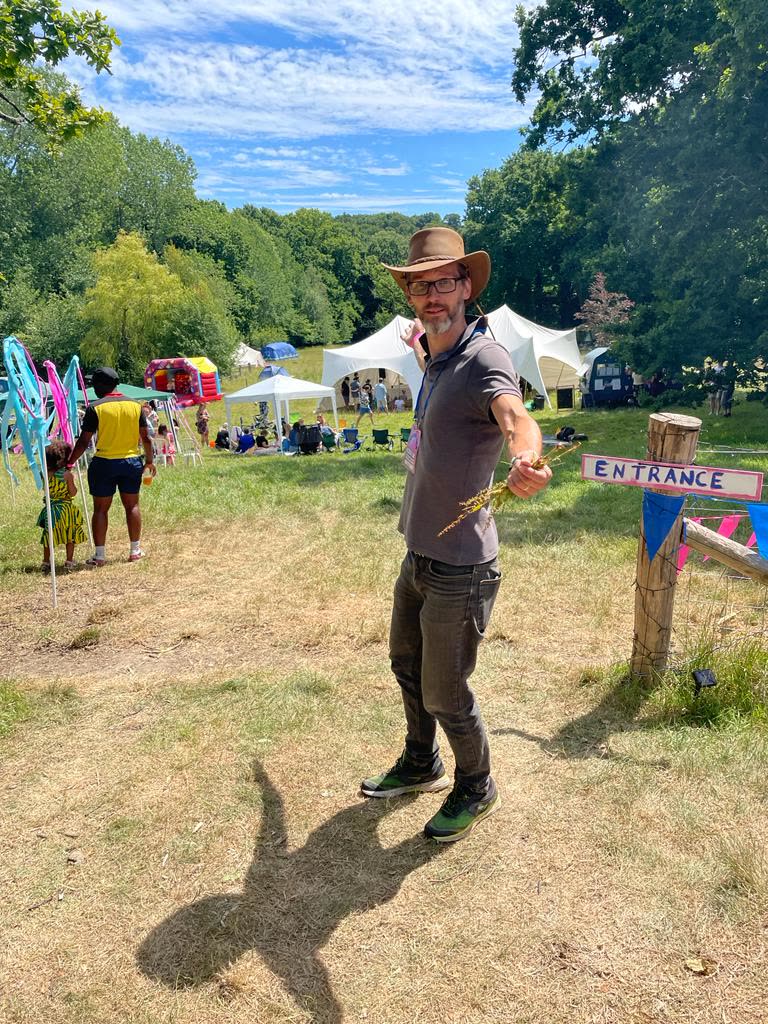 A man standing near the Hoodstock entrance in a hat